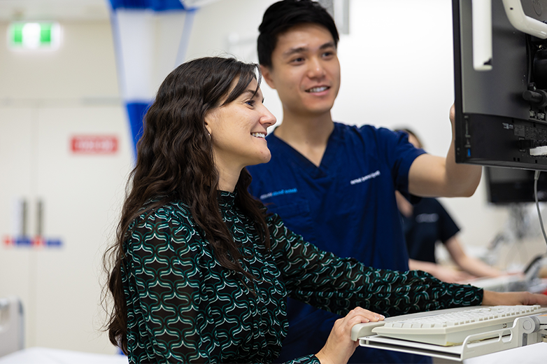 Staff working together at a hospital computer